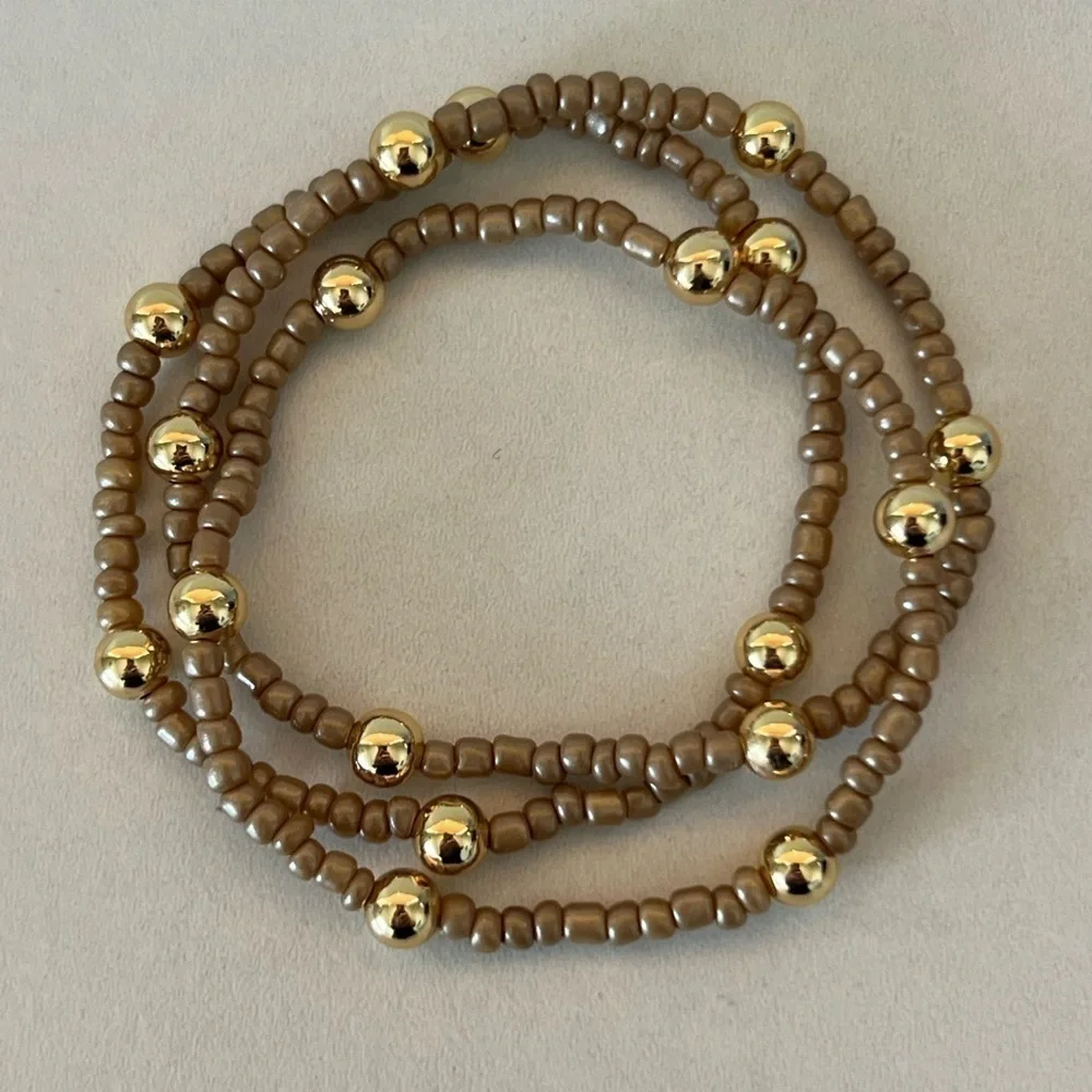 Brown/tan beaded bracelets with gold plated beads size 7”